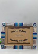 Load image into Gallery viewer, The Picha Handmade Beaded Photo Frame by Her Best Foot Forward features blue and silver beads on metal rods, handcrafted by East African women—sustainable home decor that fits a 5 x 7 photo.