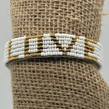 Load image into Gallery viewer, The Share the LOVE Beaded Bracelet by Her Best Foot Forward is handmade in East Africa, inspired by Maasai jewelry, with gold and white beads spelling LOVE—a beautiful, meaningful gift.