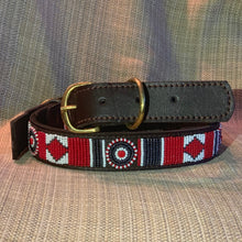 Load image into Gallery viewer, The Her Best Foot Forward Red Hot Dog Beaded Dog Collar is a handmade brown leather accessory with Maasai red, white, and black beadwork and a brass buckle, shown on beige fabric. An ethical pet collar from East Africa.