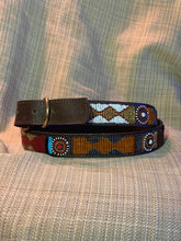 Load image into Gallery viewer, The Savanna Beaded Dog Collar by Her Best Foot Forward features vibrant Maasai beadwork—diamond and circular patterns in red, blue, white, orange, and yellow—handmade in East Africa and shown on a textured beige background.
