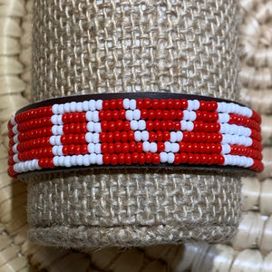 The Share the LOVE Beaded Bracelet by Her Best Foot Forward features red and white beads spelling “LOVE.” Handmade Maasai jewelry from East Africa, it’s a meaningful gift that spreads affection and brightens any day.