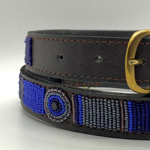A close-up of the Mia Beaded Dog Collar by Her Best Foot Forward—a dark brown leather collar with a gold buckle and blue, purple, black, and white Maasai beadwork. Chic, handmade, and ethically crafted by women artisans in East Africa.