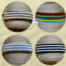 Load image into Gallery viewer, Four round images display the Safari Stripes Beaded Bracelet by Her Best Foot Forward, a handmade Maasai-inspired piece from East Africa featuring unique color patterns—gold and white, multicolored stripes, silver and white, and black and white.