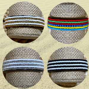 Four round images display the Safari Stripes Beaded Bracelet by Her Best Foot Forward, a handmade Maasai-inspired piece from East Africa featuring unique color patterns—gold and white, multicolored stripes, silver and white, and black and white.