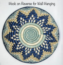 Load image into Gallery viewer, The Sunrise Handwoven Baskets by Her Best Foot Forward are round sweet grass trays from East Africa with a blue, beige, and cream star pattern. Hook on reverse for wall hanging—perfect as unique decor or an African basket display.