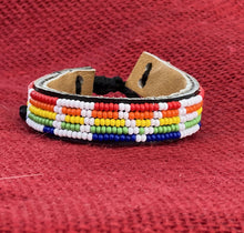 Load image into Gallery viewer, The Share the LOVE Beaded Bracelet by Her Best Foot Forward is a handmade Maasai jewelry piece from East Africa, featuring a geometric rainbow pattern on leather—a meaningful gift for someone special.