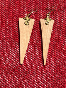 The Rosemiti Hand-Carved Rosewood Earrings by Her Best Foot Forward feature a triangular design with brass accents, shown on a textured red surface. This statement jewelry is crafted in East Africa.
