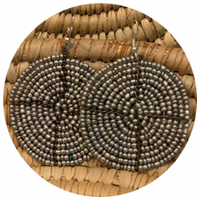 Load image into Gallery viewer, The Duara Circular Beaded Earrings by Her Best Foot Forward feature large, handmade Maasai concentric silver circles, displayed on a woven natural background.