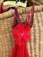 Load image into Gallery viewer, The Angels From On High Handcrafted Fiber Christmas Ornaments from Tanzania by Her Best Foot Forward, featuring a red animal face with pointed ears, are artisan-made and displayed on a wicker basket in outdoor light.